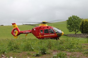 An Air Ambulance helicopter lands on the farm